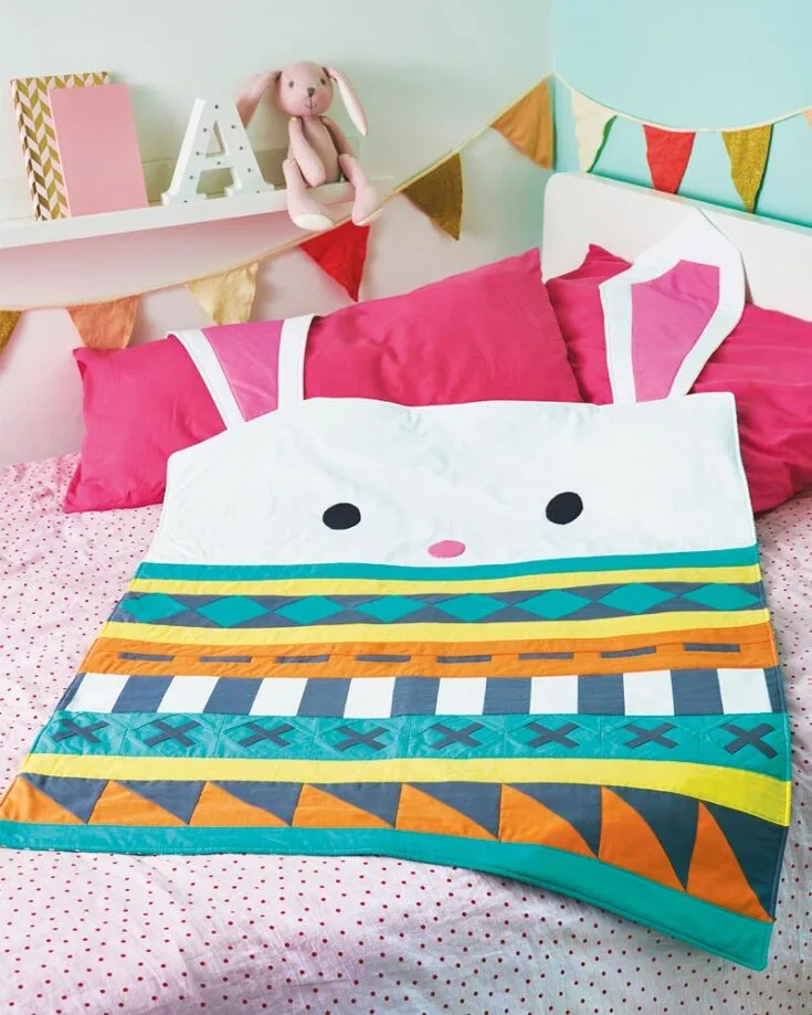 We are obsessed with how cute this bunny quilt design looks! It is complete with soft, floppy ears and a striking patchwork panel. This spring-themed baby quilt will be the perfect gift to welcome the new family member! The finished size is 32&rdquo; x 44&rdquo;.