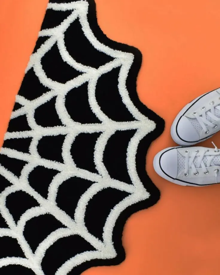 Learn to make your own rug by following this tutorial! It's a gorgeous spiderweb rug perfect for catching Halloween excitement! Embrace the festivity with your friends and family with this spinning bundle of mystery.
