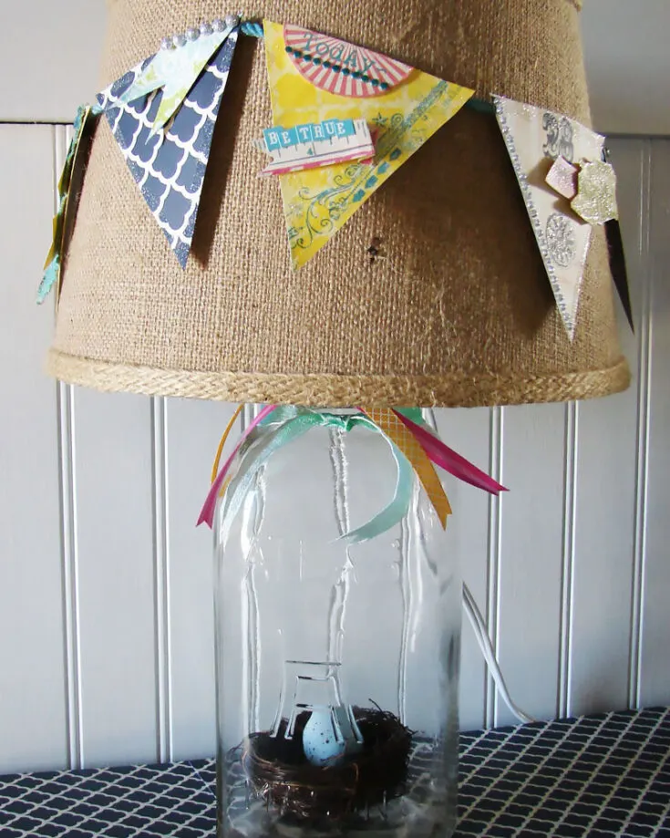 This is a great craft for you to try this spring. Get materials like the jar or the lamp at a nearby dollar tree. This craft is cheap and affordable, and it will add a twist to your plain old boring spring. Get going!