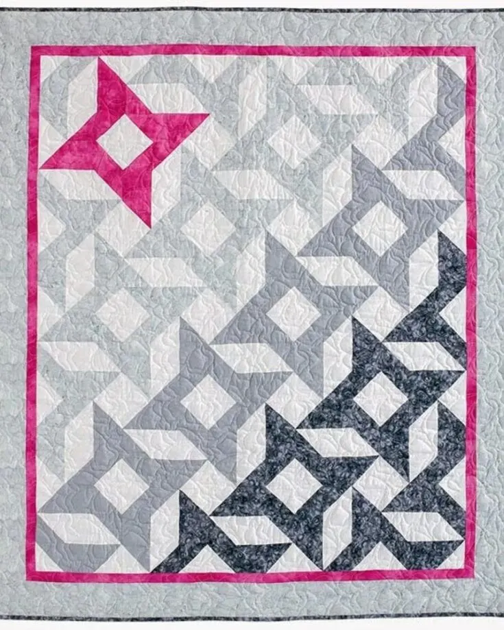 For only $10.00, make yourself a dreamy quilt with a fade effect that cascades from grays to soft whites into a vibrant splash of pink. This quilt is fun to make and embraces handmade artistry's charm. Learn how to make this pattern by clicking the link below. This design yields a 55&rdquo; x 64&rdquo; throw quilt.