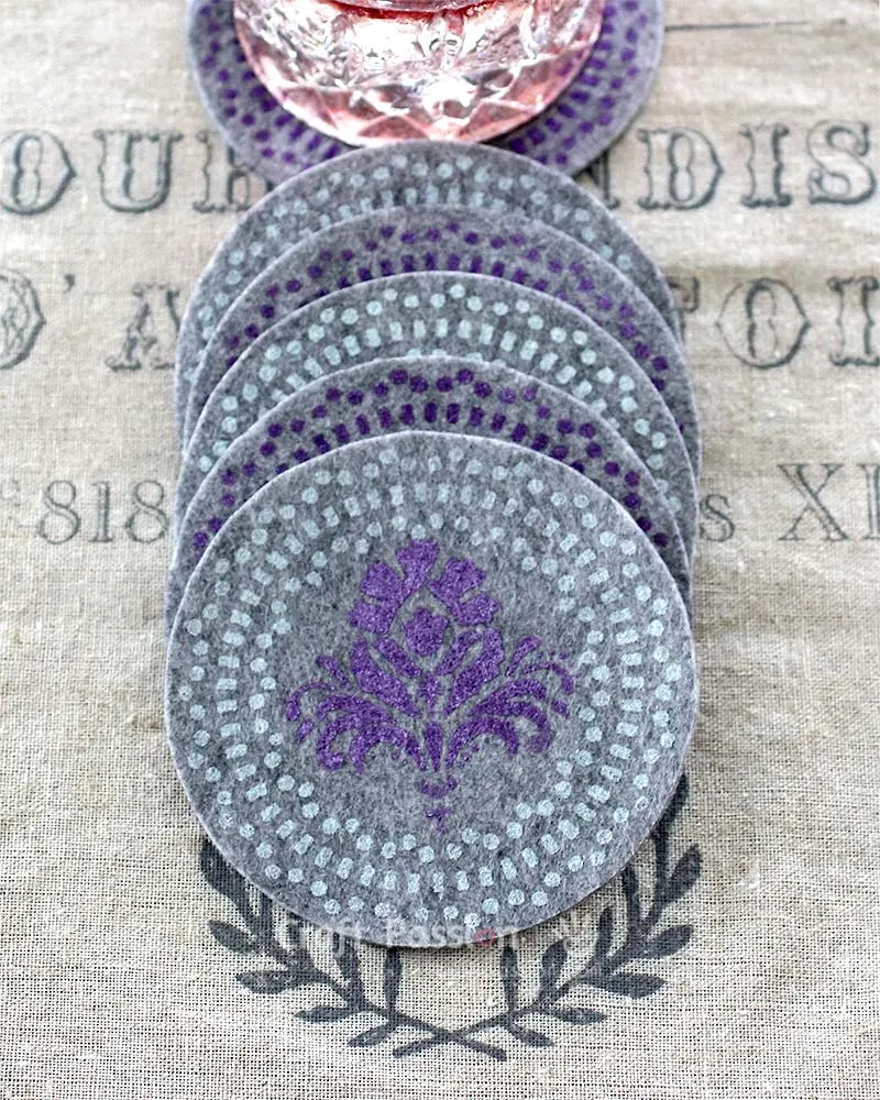 A quick and easy tutorial on how to DIY beautiful stenciled felt coasters. They're perfect to make as house warming gift. You will love these coasters.