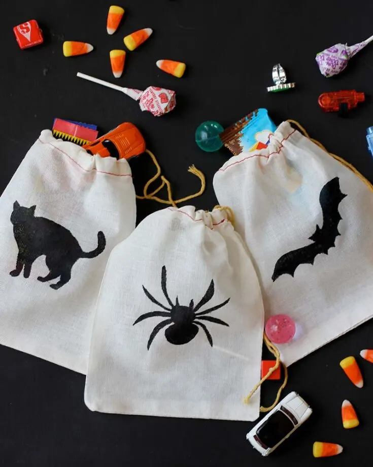 Add spooky designs to a simple cotton bag by printing and cutting out Halloween image stencils on paper. Then, use a foam brush to paint black paint over the stencils, bringing the eerie shapes to life on your bag!