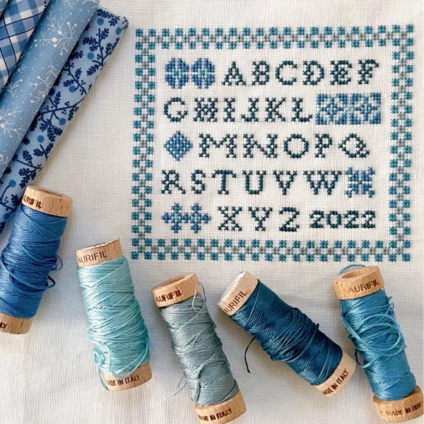font stitches in blue cross stitch pattern