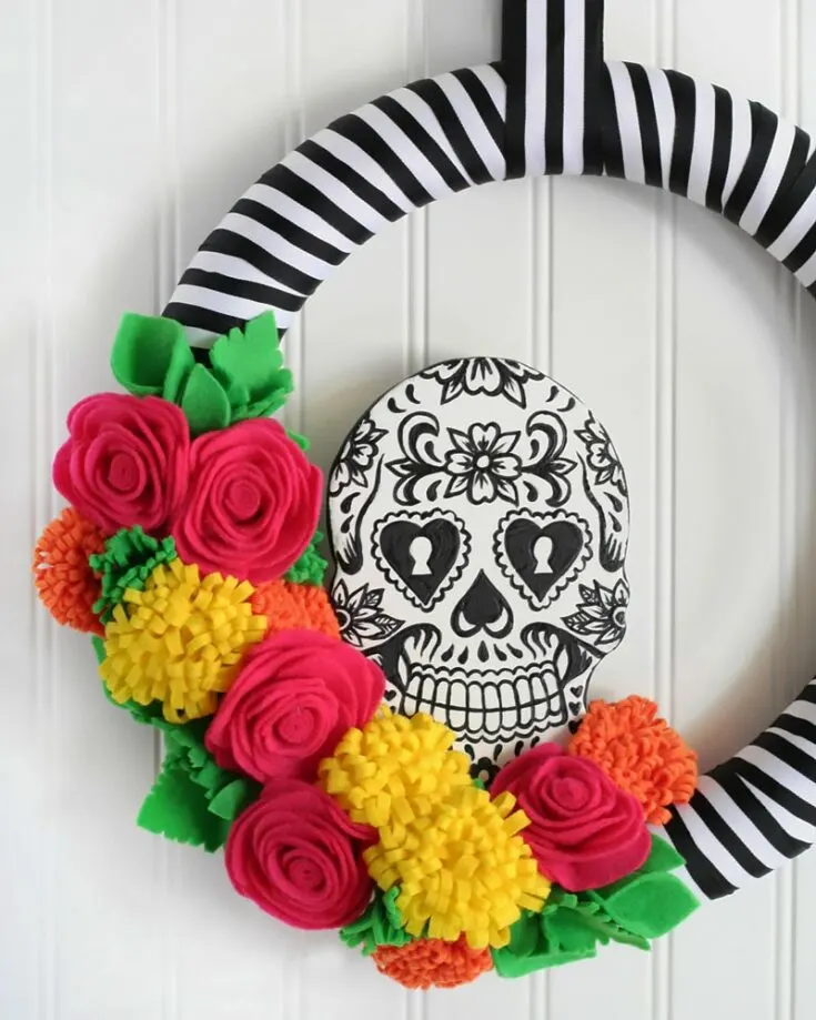 Step into a world of color and creativity with this Sugar Skull Wreath! Using vibrant colors, explore the spectrum with beautiful shades of red, pink, purple, and many more! Plus points if you use real flowers.