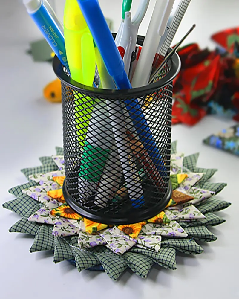 Learn how to sew a sunburst coaster with our sewing tutorial. Adapt this fabric scrap-buster triangle fold coaster method to make a larger rug.