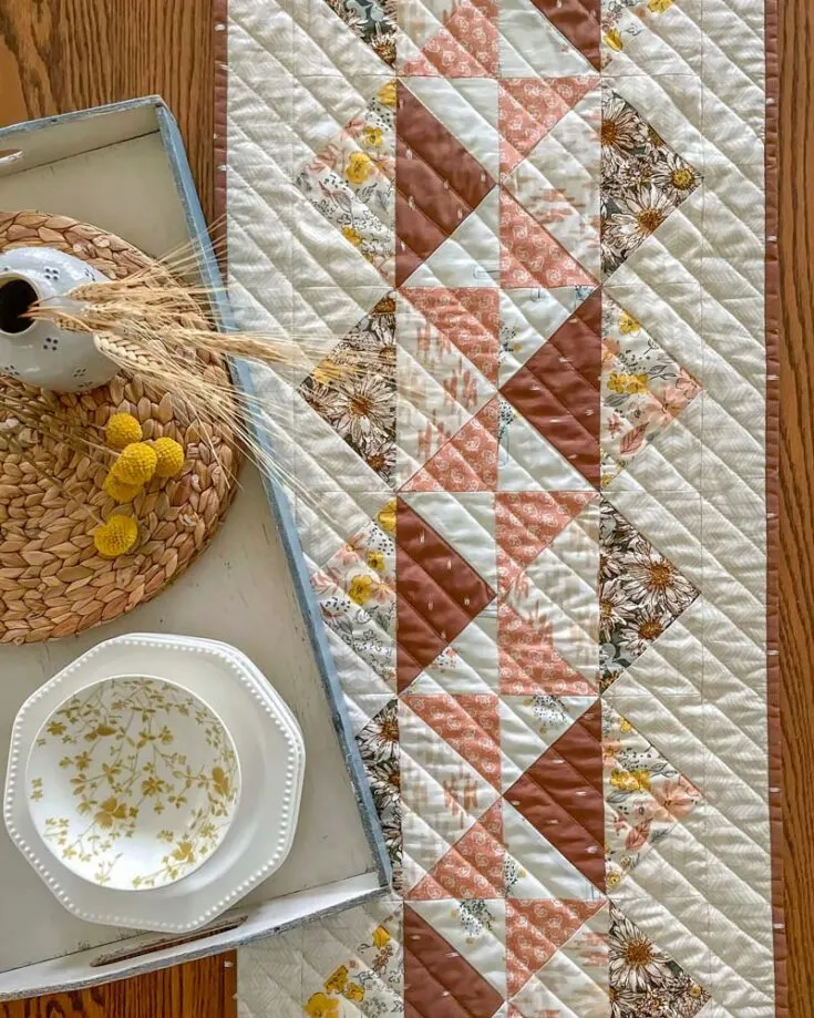 Have a look at this glorious design by Sharon! It's so simple yet so elegant to decorate on your tabletop. It's a fast project that can easily be made over the weekend, and it features 4-at-a-time Flying Geese units for faster piecing.&nbsp; Table runner size: 16 &frac12;" x 72 &frac12;"&nbsp;