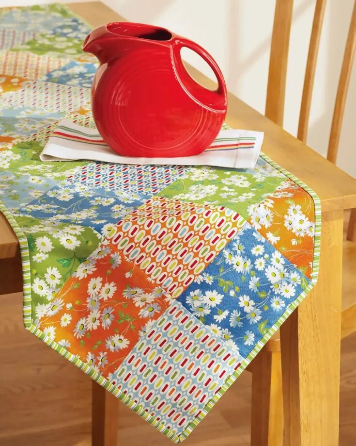 Doesn't this accent piece look so stylish and modern? It's a colorful runner with rows of six-inch squares that bring a dynamic effect, and look so visually pleasing. It's an easy quilt project for beginners, perfect for every season. Table runner size: 16 ?" x 78 ?"