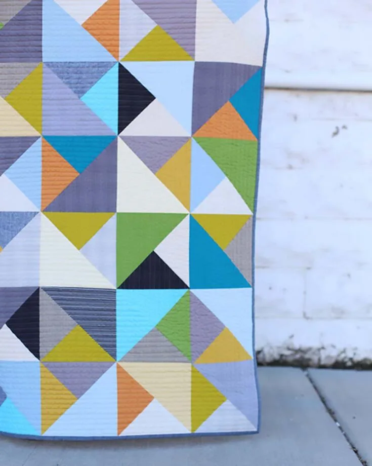 Now, if you&rsquo;re in the mood for visually appealing and geometrical quilt patterns for beginners, this design takes the win! Made with the half square triangles method (HSTs) and ten-inch fabric strips, this project is great for beginners looking for a quick and satisfying project. With clear instructions and helpful visuals, you&rsquo;ll enjoy making a cozy quilt that showcases your quilting skills effortlessly. The finished size is 51&rdquo; x 51&rdquo;.