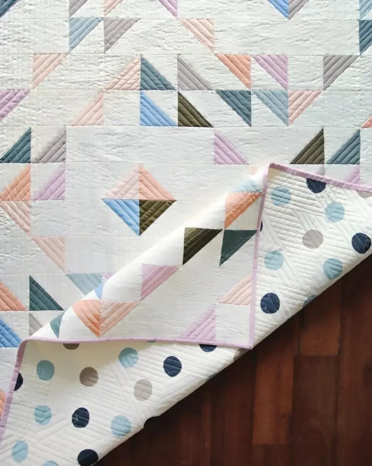 Elegant! That&rsquo;s the word that comes to mind when looking at this gorgeous Summer Haze quilt from Suzy Quilts! It perfectly captures the essence of warm, sunny days with its fresh, airy layout. It offers a modern aesthetic to your quilts and uses the simple half-square triangle blocks technique. This quilt is 36&rdquo; x 51&rdquo;, but this pattern has instructions to create queen, throw, twin, and baby quilt sizes.