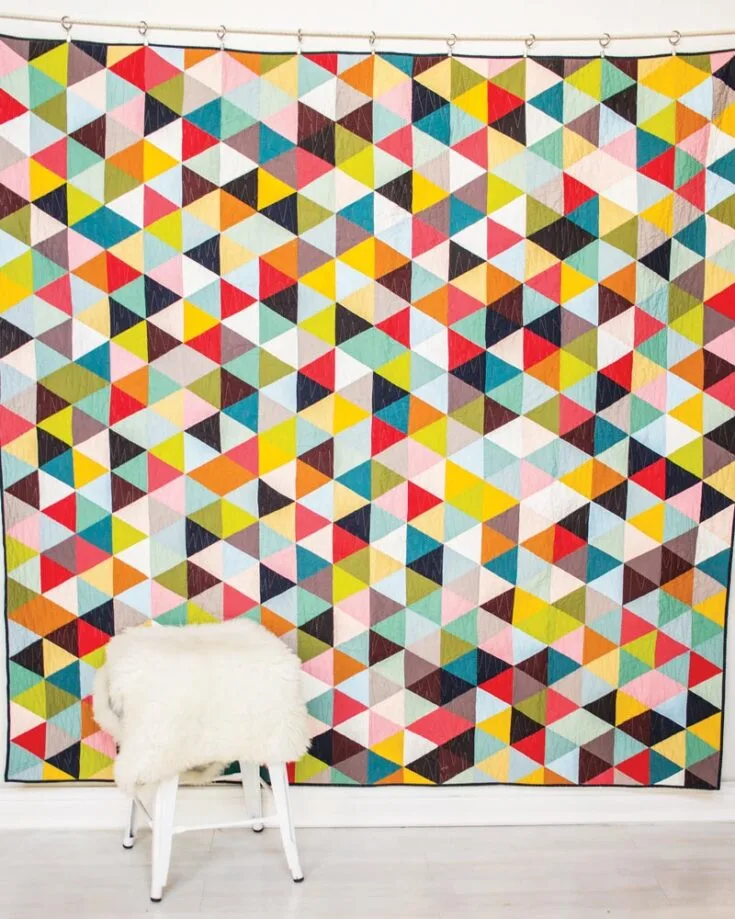 Looking for a well-put geometric quilt that is aesthetically pleasing yet colorful and vibrant? Then look no further than this dazzling beginner-friendly pattern that allows you to use up an assortment of colors from your scrap stash! It's easy to make; all you need to do is click the link below. This design yields an 88" x 90" quilt.&nbsp;