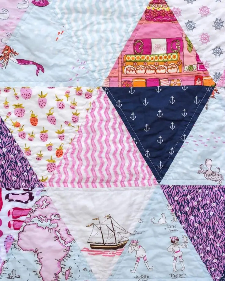 Speaking of easy quilt patterns, this simple yet beautiful Triangle Quilt is one you must try! This pattern will guide you to transform simple triangles into a stunning geometric design that allows you to showcase your favorite fabric prints. It&rsquo;s also a stash-buster quilt! This design is easy to work with, and the finished size yields a baby or a lap quilt of 46&rdquo; x 72&rdquo;.