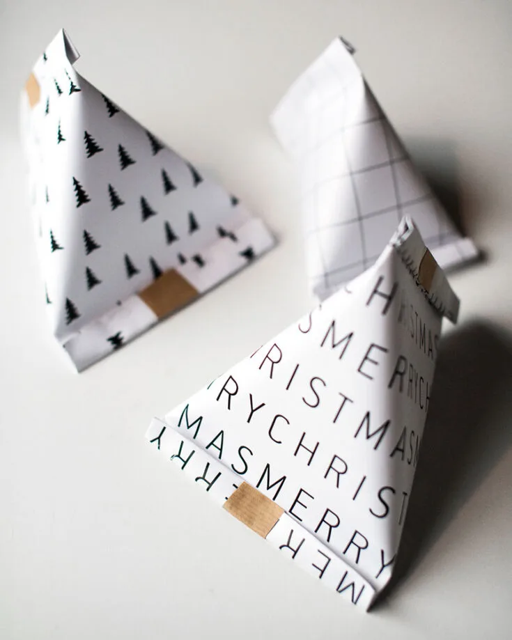 Create these cute triangular gift bags. Simply print out a design using the downloadable pattern included! They're perfect for holding small gifts for an advent calendar or filling with candy for guests.
