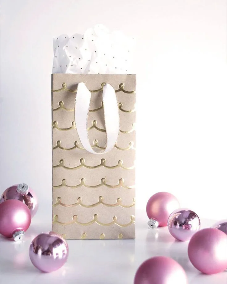 Make your Christmas tree shine even brighter by crafting fun gift bags out of wrapping paper! These matching bags not only look great but also add a personal touch that your friends and family will love.